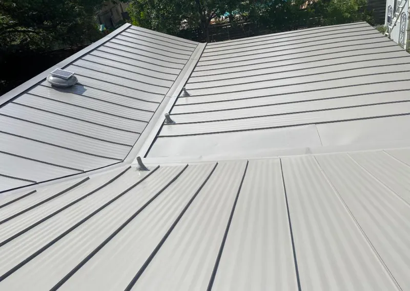 Solar attic fan installed on a metal roof for Roof Ventilation in Glenpool